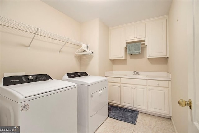 4045 Bonnett Creek Ln, Hoschton, GA 30548 - washroom with independent washer and dryer, light tile patterned flooring, and cabinet space