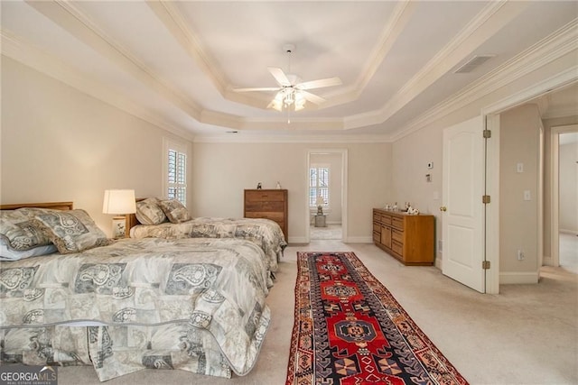4045 Bonnett Creek Ln, Hoschton, GA 30548 - bedroom with a tray ceiling, light carpet, ornamental molding, ceiling fan, and baseboards