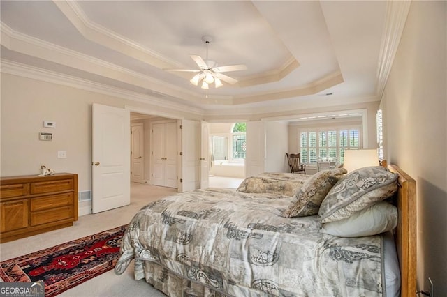 4045 Bonnett Creek Ln, Hoschton, GA 30548 - carpeted bedroom with a raised ceiling, ornamental molding, ensuite bath, and ceiling fan
