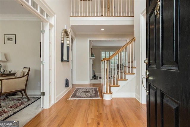 4045 Bonnett Creek Ln, Hoschton, GA 30548 - foyer featuring crown molding, light wood-style flooring, baseboards, and stairs