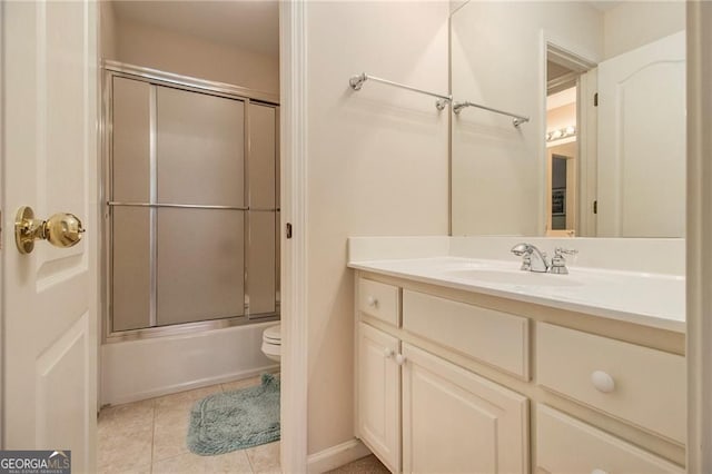4045 Bonnett Creek Ln, Hoschton, GA 30548 - bathroom with vanity, combined bath / shower with glass door, tile patterned floors, and toilet