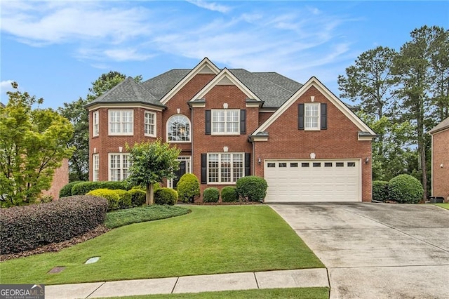 4045 Bonnett Creek Ln, Hoschton, GA 30548 - georgian-style home featuring brick siding, a garage, driveway, and a front lawn