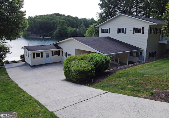 327 Chatuge Village Cir, Hayesville, NC 28904 - view of front facade with concrete driveway, a front lawn, a wooded view, and a water view