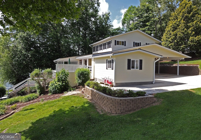 327 Chatuge Village Cir, Hayesville, NC 28904 - view of front facade with an attached carport, a front lawn, concrete driveway, and stairway
