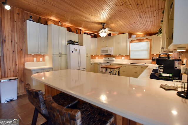 327 Chatuge Village Cir, Hayesville, NC 28904 - kitchen with white appliances, light countertops, a peninsula, a kitchen bar, and ceiling fan