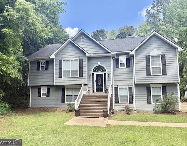 raised ranch with a front lawn