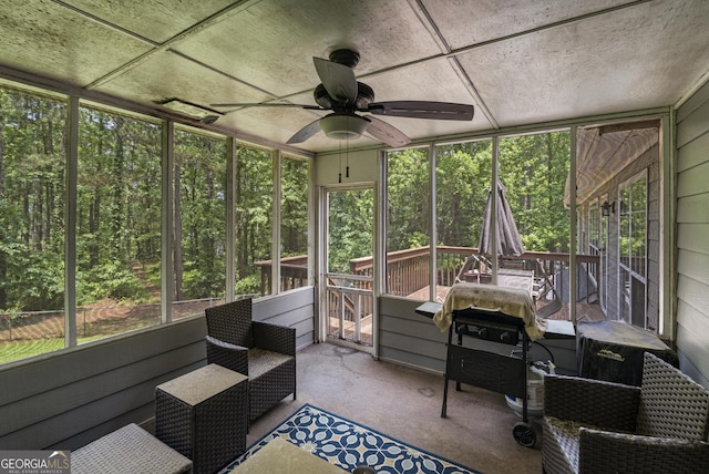 sunroom / solarium with a ceiling fan and healthy amount of natural light
