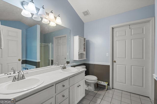 full bath with vaulted ceiling, a shower stall, tile patterned flooring, double vanity, and toilet