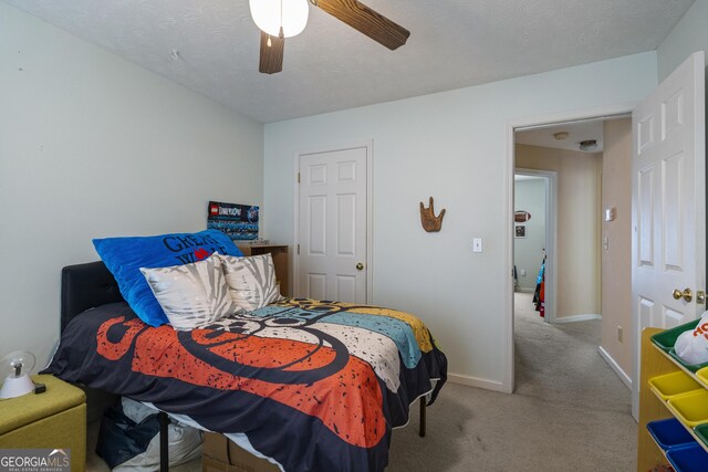 carpeted bedroom with baseboards and a ceiling fan