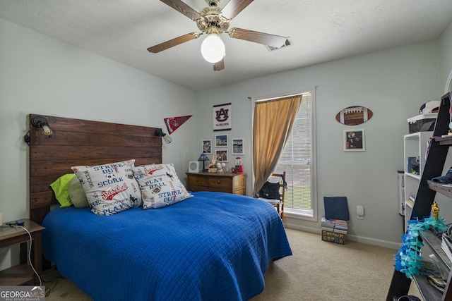 carpeted bedroom with a ceiling fan and baseboards
