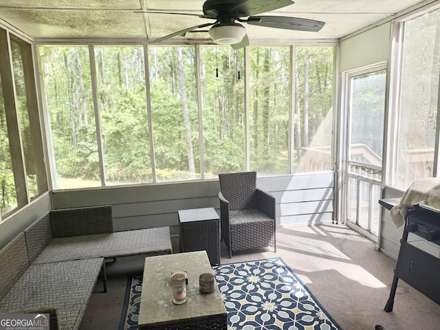 sunroom / solarium with a ceiling fan