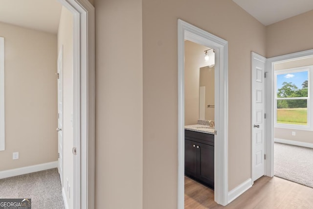 123 Oak Rd, Locust Grove, GA 30248 - corridor with baseboards, a sink, and light wood-type flooring