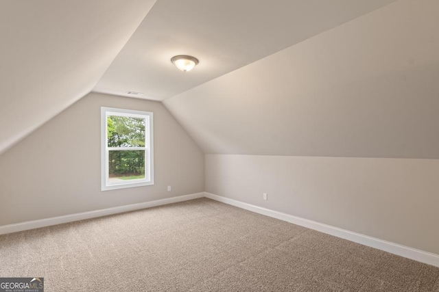 123 Oak Rd, Locust Grove, GA 30248 - additional living space with carpet flooring, baseboards, and vaulted ceiling