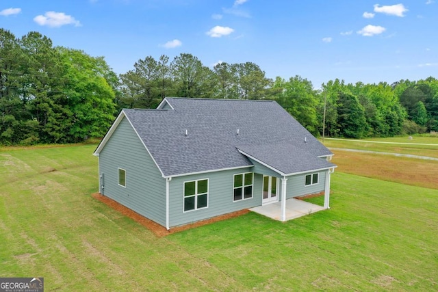 123 Oak Rd, Locust Grove, GA 30248 - rear view of property with a shingled roof, a lawn, and a patio