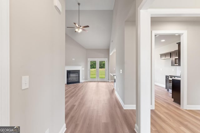 123 Oak Rd, Locust Grove, GA 30248 - corridor featuring light wood-style flooring, high vaulted ceiling, and baseboards