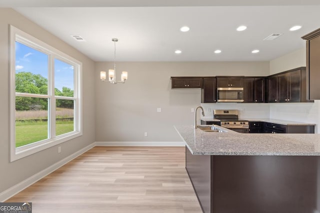 123 Oak Rd, Locust Grove, GA 30248 - kitchen featuring stainless steel appliances, a sink, baseboards, a chandelier, and recessed lighting