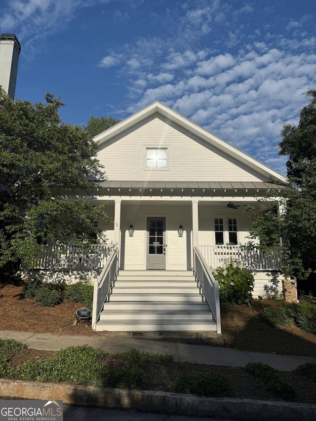 10583 Serenbe Ln, Palmetto, GA 30268 - view of front of house with covered porch and a metal roof