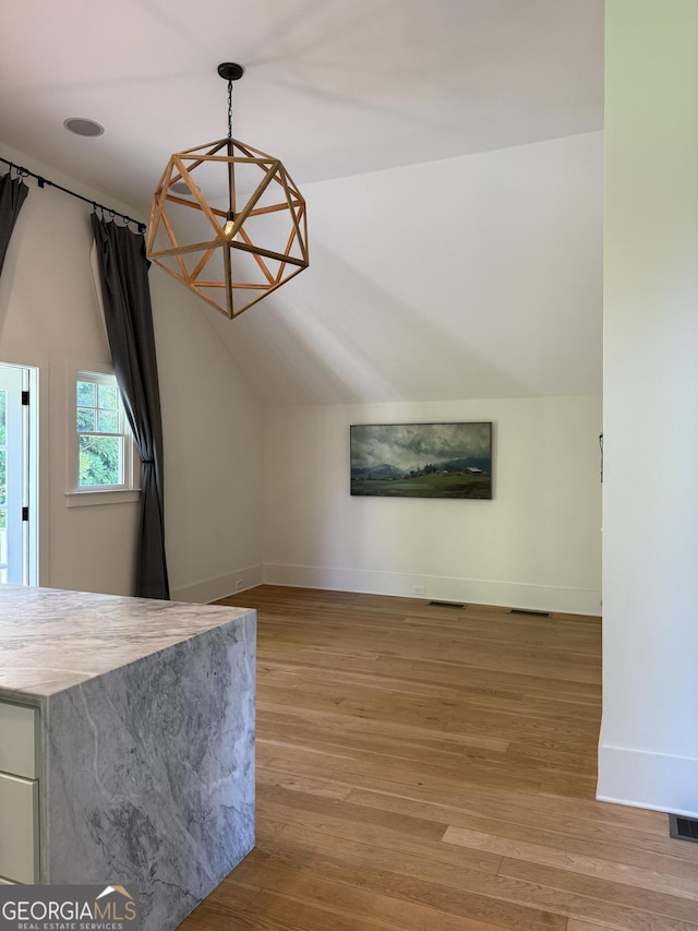 10583 Serenbe Ln, Palmetto, GA 30268 - unfurnished living room featuring lofted ceiling and light wood-style flooring