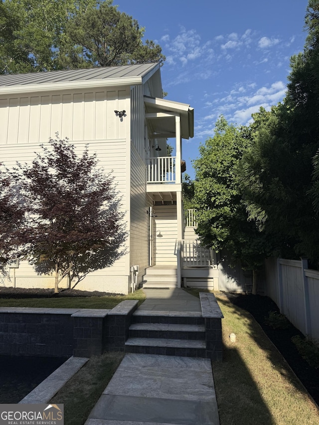10583 Serenbe Ln, Palmetto, GA 30268 - view of exterior entry featuring a balcony and board and batten siding