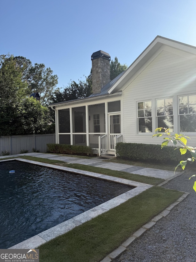 10583 Serenbe Ln, Palmetto, GA 30268 - back of house featuring a chimney and a sunroom