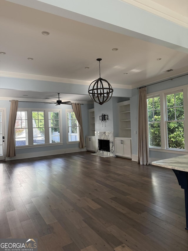 10583 Serenbe Ln, Palmetto, GA 30268 - unfurnished living room with crown molding, dark wood finished floors, a chandelier, a high end fireplace, and a ceiling fan