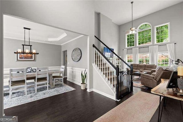 214 Crestmont Way, Canton, GA 30114 - staircase featuring wood finished floors, a high ceiling, ceiling fan, a chandelier, and wainscoting