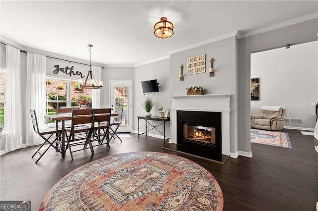 214 Crestmont Way, Canton, GA 30114 - dining room with ornamental molding, wood finished floors, a glass covered fireplace, baseboards, and a chandelier