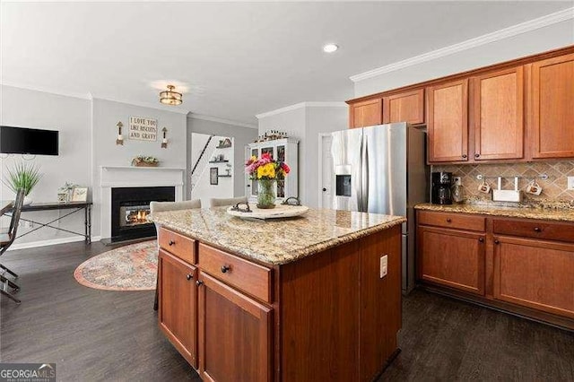 214 Crestmont Way, Canton, GA 30114 - kitchen with dark wood-type flooring, ornamental molding, a center island, light stone counters, and backsplash