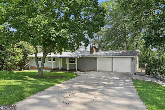 54 Owl Ct, Monticello, GA 31064 - view of front facade with an attached garage, driveway, covered porch, a chimney, and a front yard
