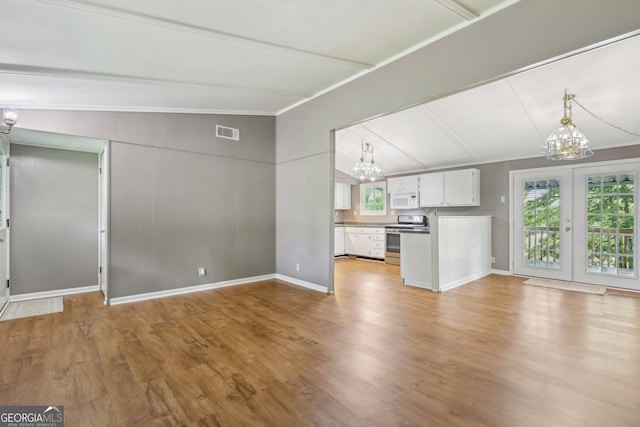 54 Owl Ct, Monticello, GA 31064 - unfurnished living room with a chandelier, lofted ceiling, wood finished floors, and baseboards
