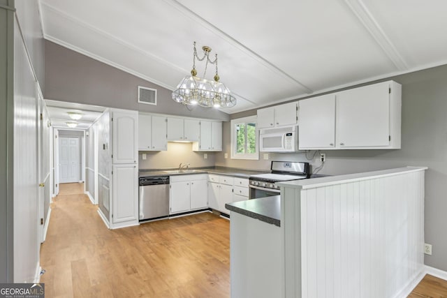 54 Owl Ct, Monticello, GA 31064 - kitchen featuring stainless steel appliances, lofted ceiling, a sink, white cabinetry, and light wood finished floors