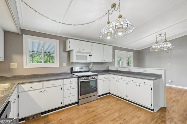 54 Owl Ct, Monticello, GA 31064 - kitchen featuring white microwave, stainless steel range with gas cooktop, lofted ceiling, healthy amount of natural light, and a chandelier