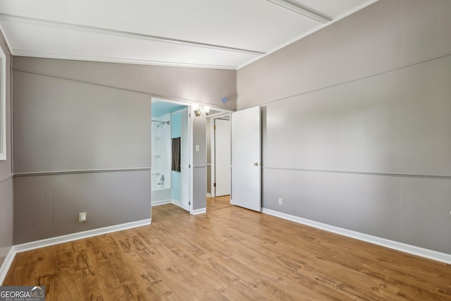54 Owl Ct, Monticello, GA 31064 - unfurnished bedroom featuring light wood-style floors, vaulted ceiling, and baseboards