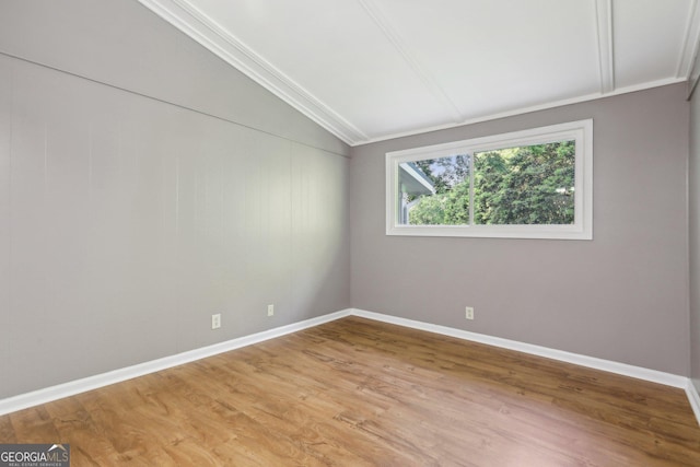54 Owl Ct, Monticello, GA 31064 - spare room featuring lofted ceiling, light wood-type flooring, baseboards, and crown molding