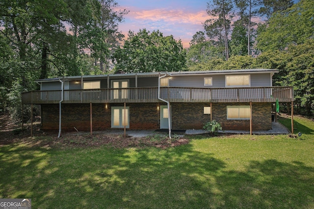 54 Owl Ct, Monticello, GA 31064 - back of house featuring a yard, a deck, view of wooded area, and brick siding