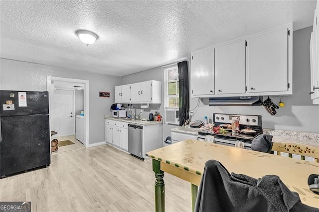 kitchen with appliances with stainless steel finishes, light wood-type flooring, light countertops, white cabinets, and a textured ceiling
