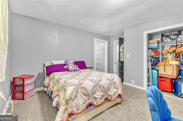 carpeted bedroom featuring a textured ceiling, a closet, and baseboards