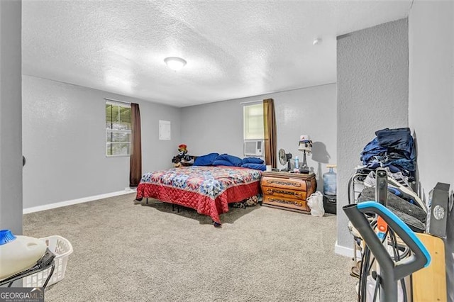 carpeted bedroom with a textured ceiling, baseboards, and a textured wall