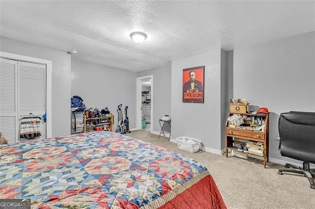 bedroom featuring carpet floors, a textured ceiling, a closet, and baseboards