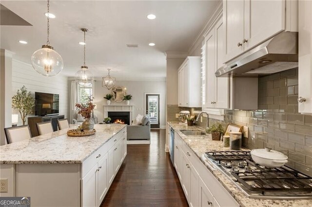 3000 Haven Mill Ln, Milton, GA 30004 - living area with a warm lit fireplace, wood walls, crown molding, and a chandelier
