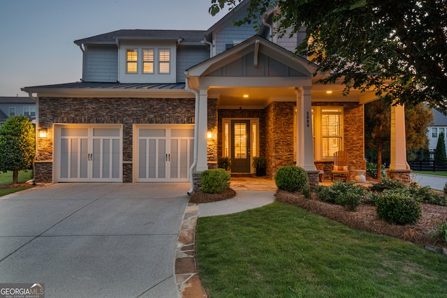 3000 Haven Mill Ln, Milton, GA 30004 - craftsman house featuring stone siding, a garage, driveway, a standing seam roof, and covered porch