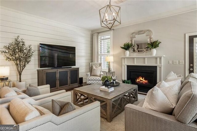 3000 Haven Mill Ln, Milton, GA 30004 - living room with stairway, a glass covered fireplace, wood finished floors, a chandelier, and crown molding