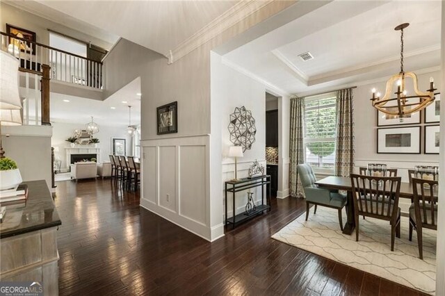 3000 Haven Mill Ln, Milton, GA 30004 - dining area with a decorative wall, a chandelier, dark wood-type flooring, crown molding, and wainscoting