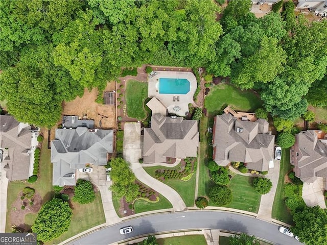 view of property location with nearby suburban area and a pool area
