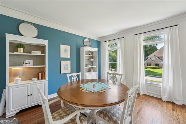 dining area with crown molding, dark wood-type flooring, and baseboards