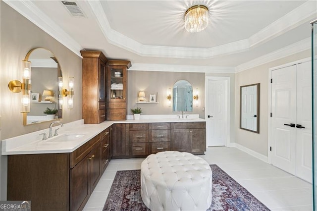 bathroom with vanity, tile patterned floors, crown molding, a raised ceiling, and a chandelier