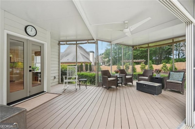 sunroom featuring french doors and a ceiling fan