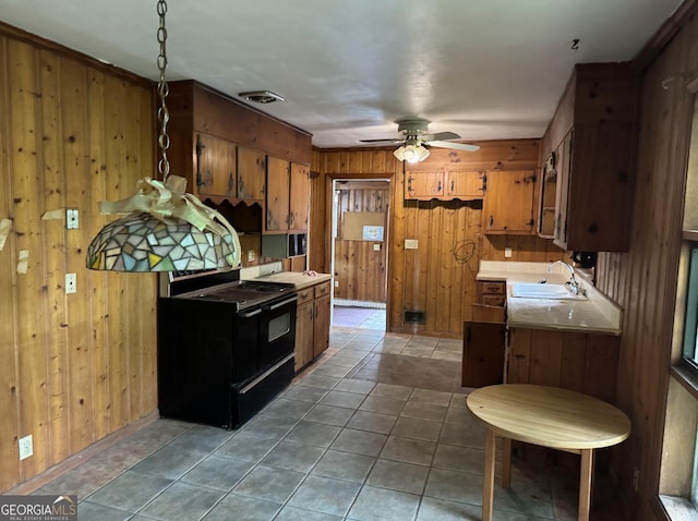 4720 Ben Hill Rd, South Fulton, GA 30349 - kitchen featuring black electric range, wood walls, a sink, brown cabinetry, and ceiling fan
