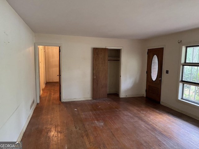 4720 Ben Hill Rd, South Fulton, GA 30349 - unfurnished bedroom with hardwood / wood-style floors, multiple windows, baseboards, and a closet