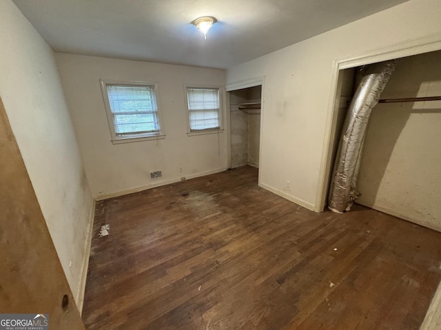 4720 Ben Hill Rd, South Fulton, GA 30349 - unfurnished bedroom featuring multiple closets and wood finished floors